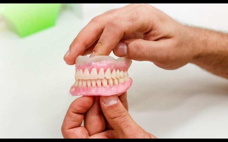 Dentist fitting dentures for a patient ensuring comfort and proper alignment